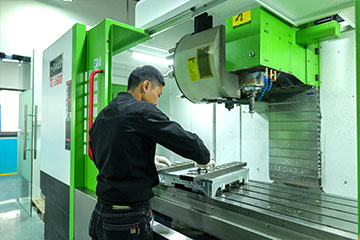 A colleague is cleaning a CNC machine tool in our workshop.